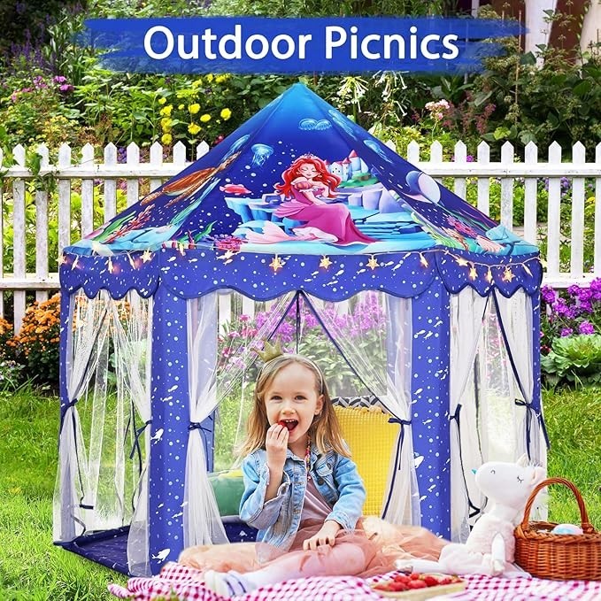 Sea Dragon Dreams blue mermaid princess castle play tent with star lights, set up outdoors for a child's picnic.