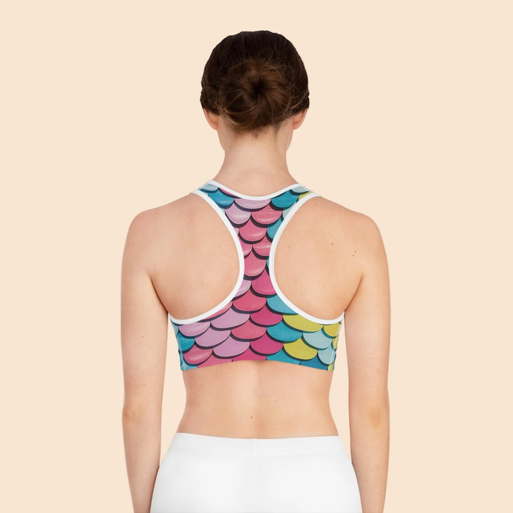 Back view of Sea Dragon Dreams seamless sports bra featuring a vibrant multi-colored mermaid scale print and racerback.