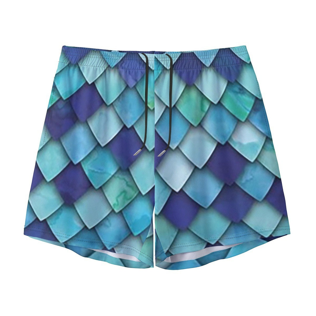 Sea Dragon Dreams men's swim shorts featuring a vibrant blue and teal mermaid scale pattern with an elastic waistband.