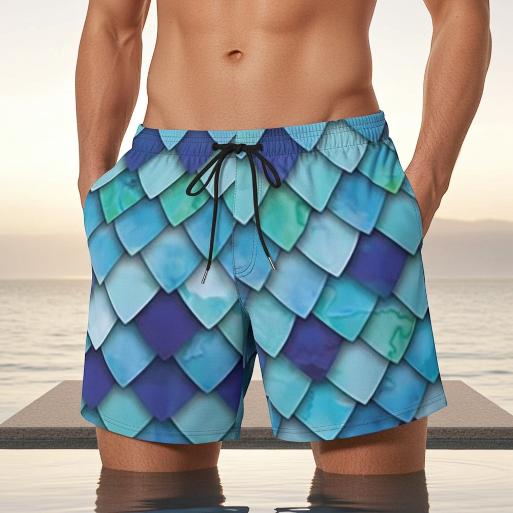 Sea Dragon Dreams men's swim shorts featuring a vibrant blue and teal mermaid scale pattern with an elastic waistband.
