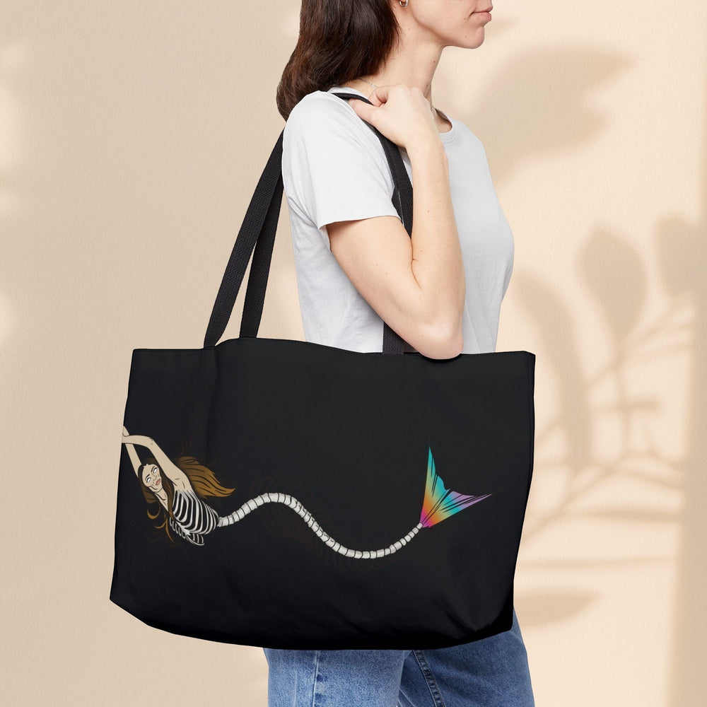 Sea Dragon Dreams weekender tote bag featuring a mermaid skeleton print with a rainbow tail on a black polyester bag