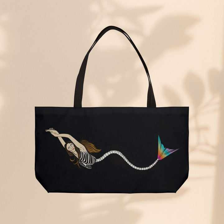 Sea Dragon Dreams mermaid skeleton weekender tote bag with black woven handles and vibrant rainbow tail detail