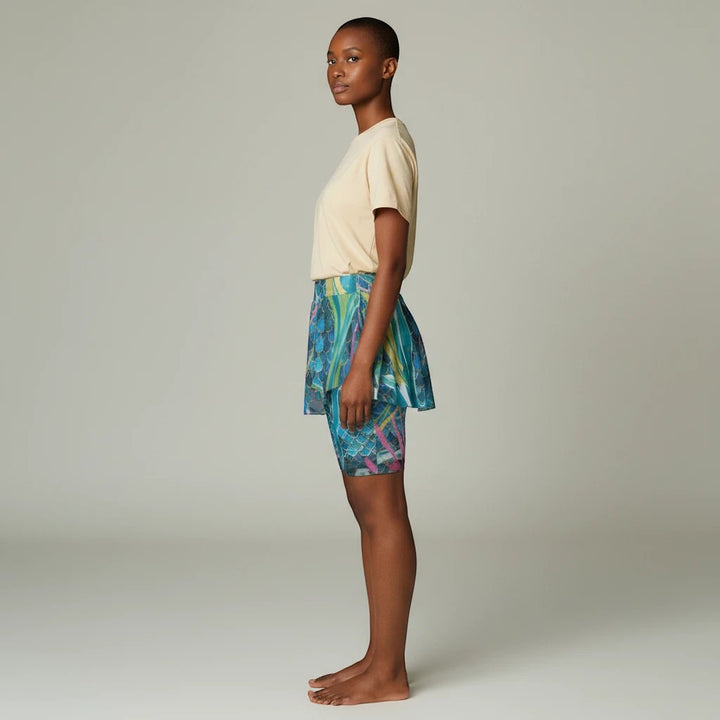 Model wearing Sea Dragon Dreams mermaid print sports skort with built-in shorts for yoga and running, side view.