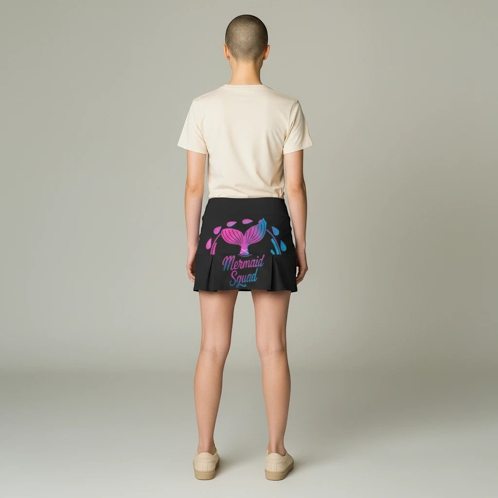 Sea Dragon Dreams Mermaid Squad active skort in black with pink and blue tail graphic, worn by a model from behind.
