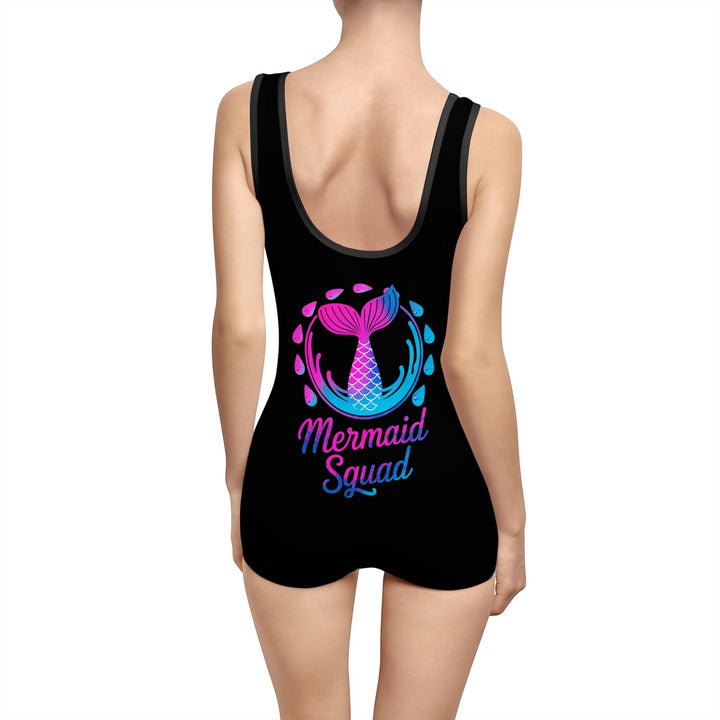 Sea Dragon Dreams vintage-style black one-piece swimsuit with a pink and blue Mermaid Squad graphic on the back