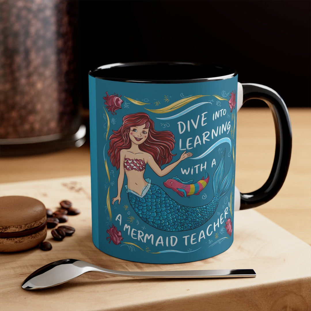Sea Dragon Dreams ceramic accent mug with a mermaid teacher illustration and Dive Into Learning text, black handle.