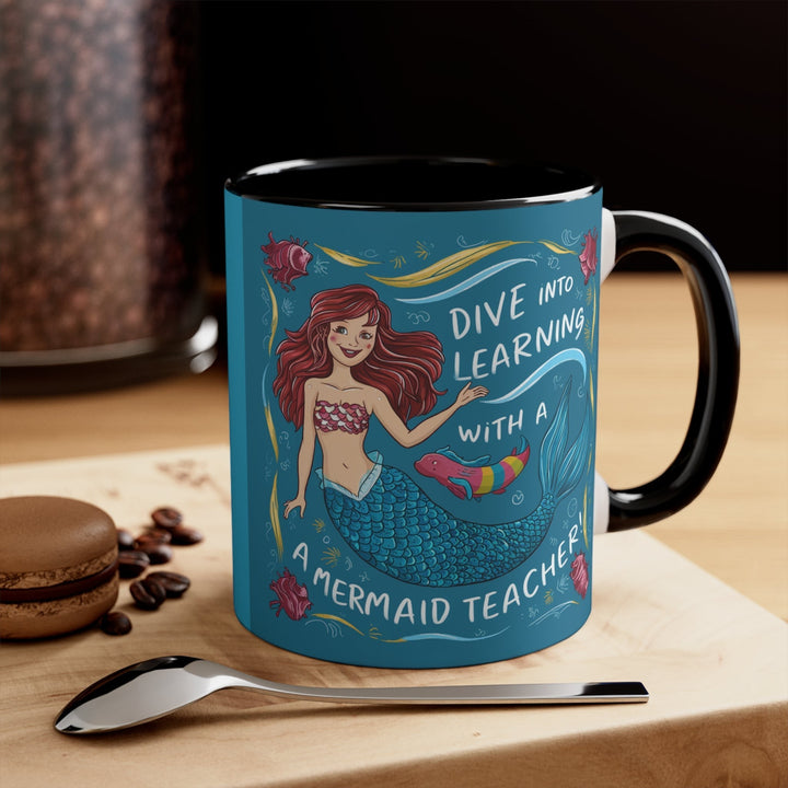 Sea Dragon Dreams ceramic accent mug with a mermaid teacher illustration and Dive Into Learning text, black handle.