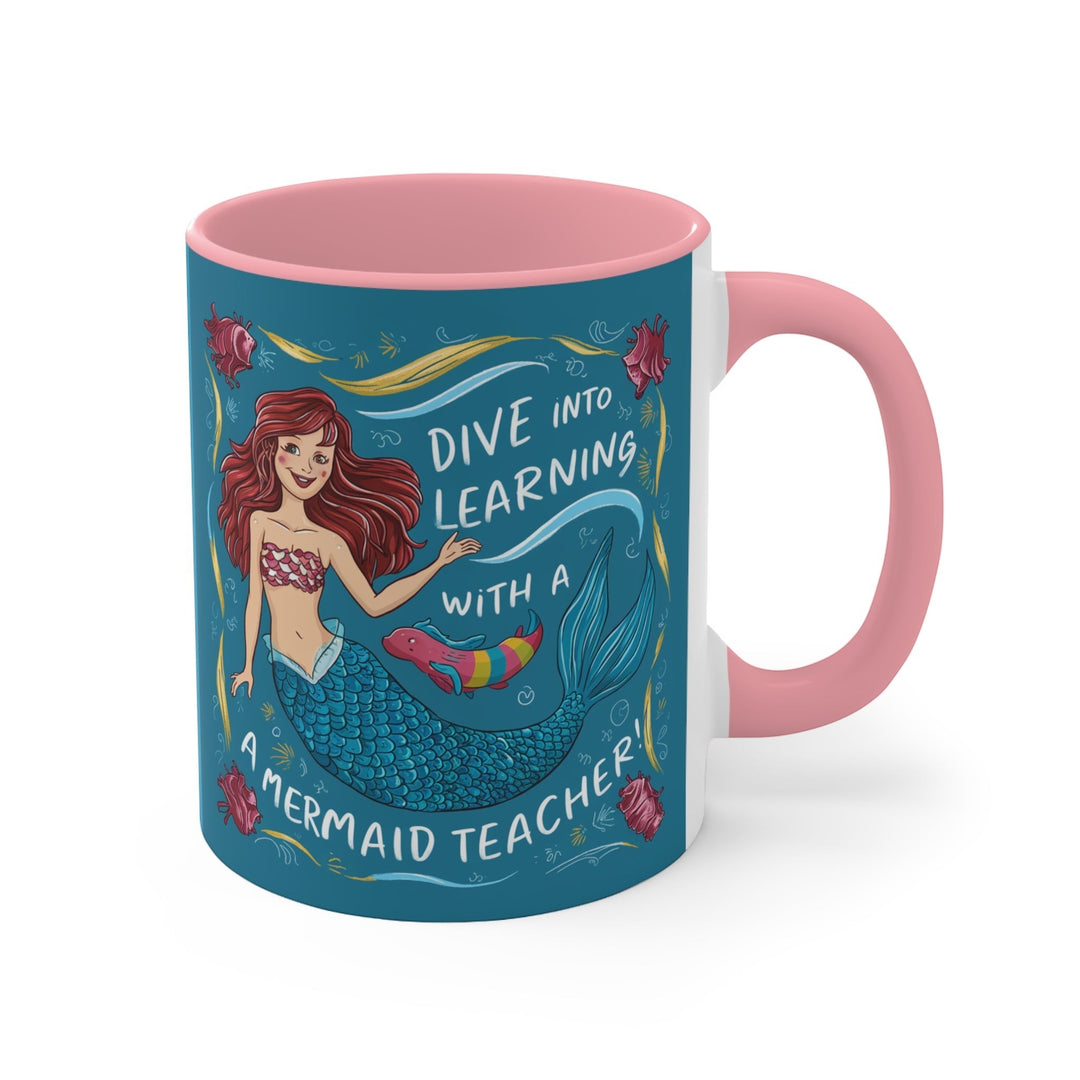 Sea Dragon Dreams ceramic accent mug with pink interior and handle featuring a mermaid teacher illustration.