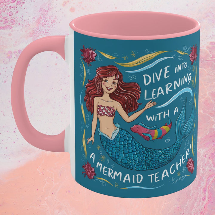 Sea Dragon Dreams ceramic accent mug with a pink handle and interior featuring a mermaid teacher illustration.