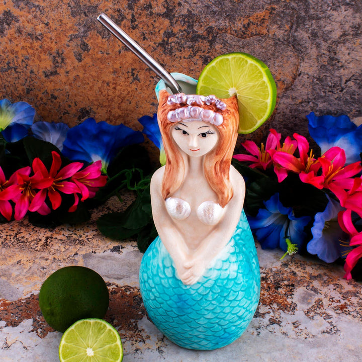 Sea Dragon Dreams 16 oz ceramic mermaid tiki mug with hand-painted tail and hair, styled with lime and tropical flowers.