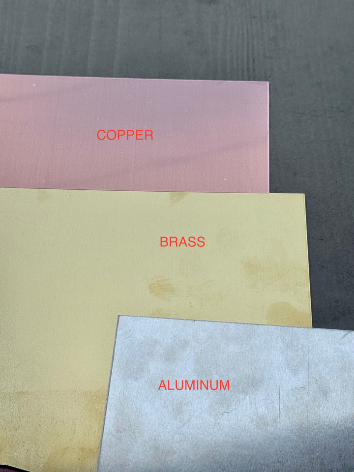Sea Dragon Dreams material samples showing copper, brass, and aluminum sheets used for handmade jewelry