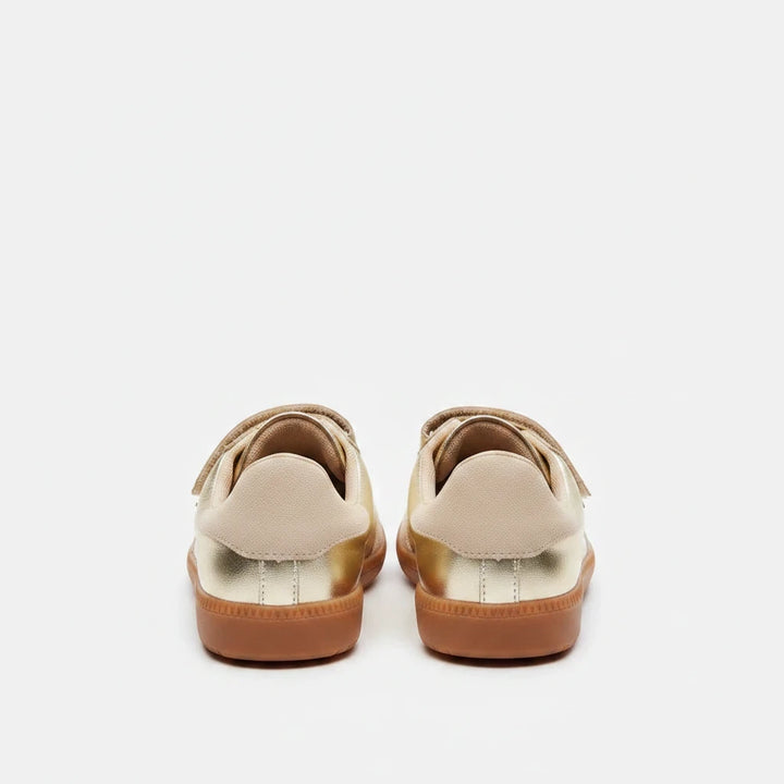 Sea Dragon Dreams Steve Madden Momentum gold metallic vegan leather sneakers, back view showing gum soles.