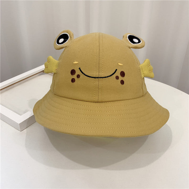 Sea Dragon Dreams mustard yellow baby bucket hat featuring a cute embroidered frog face with 3D eyes and side fins