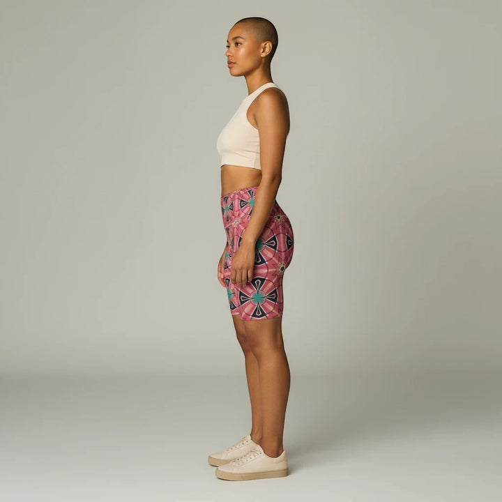 Model wearing Sea Dragon Dreams Mystic Circles floral workout shorts with a beige crop top in a side profile view.