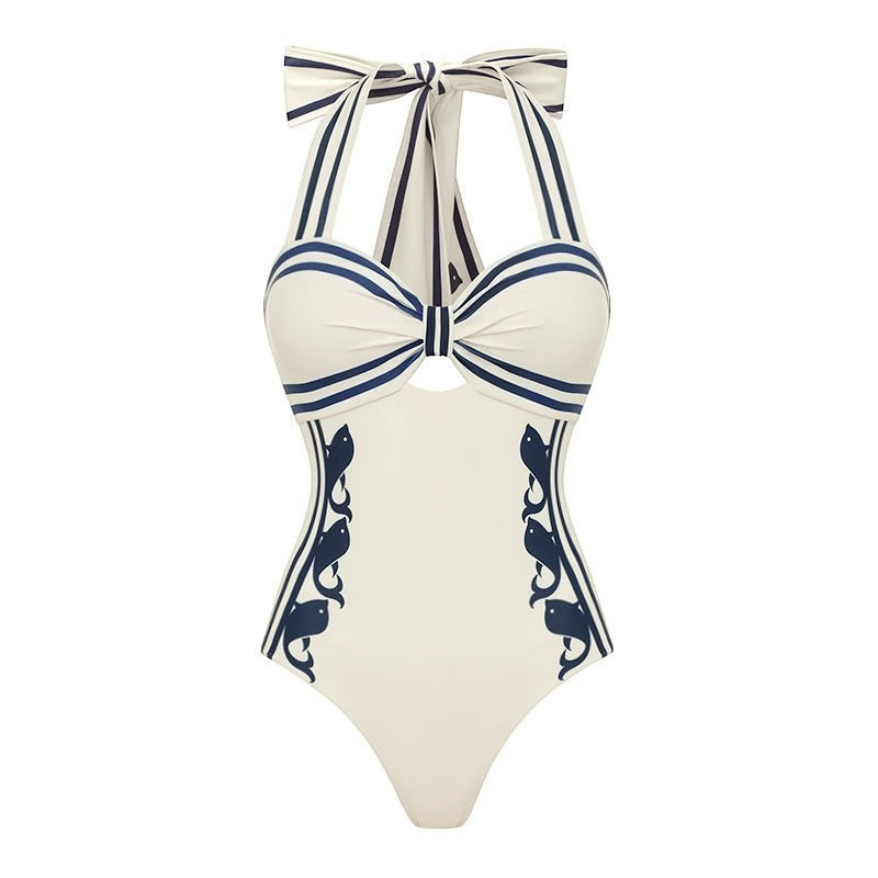 Sea Dragon Dreams white one-piece swimsuit with navy blue nautical stripes and decorative side patterns