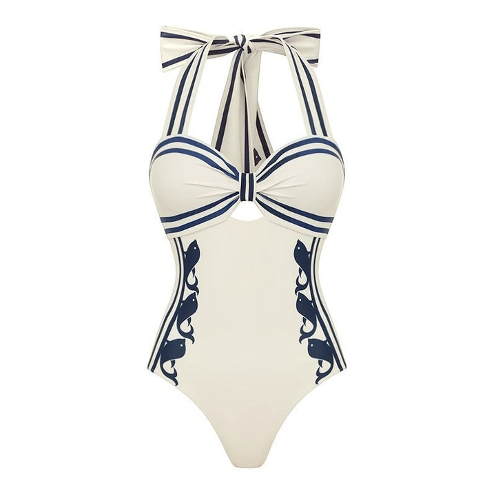 Sea Dragon Dreams white one-piece swimsuit with navy blue nautical stripes and decorative side patterns