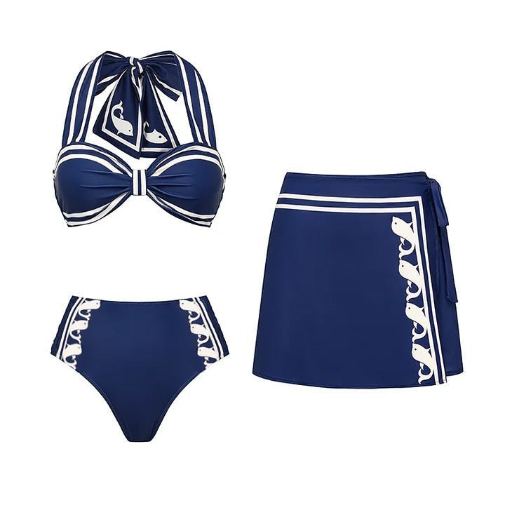 Sea Dragon Dreams navy blue halter bikini set with high-waisted bottoms and matching wrap skirt, featuring whale print