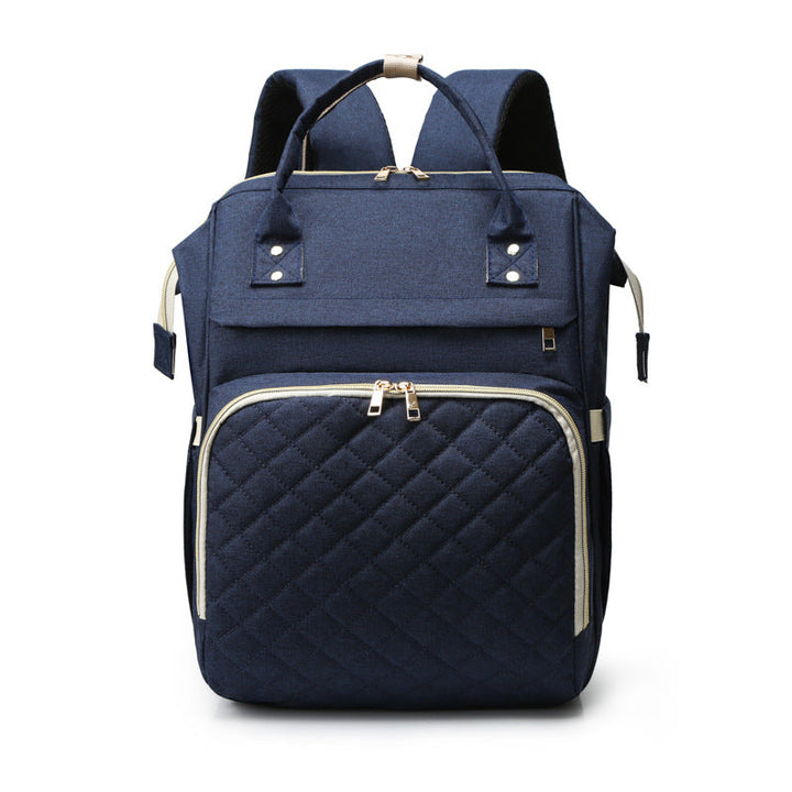 Sea Dragon Dreams navy blue quilted diaper backpack with gold zippers and spacious storage for baby essentials