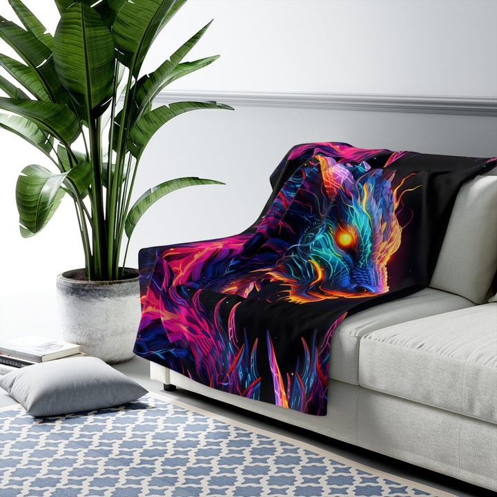 Sea Dragon Dreams neon dragon sherpa fleece blanket draped over a white sofa in a modern living room setting.
