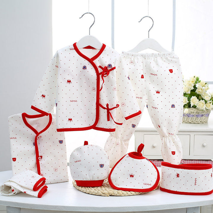 Sea Dragon Dreams newborn baby essentials set in white cotton with red trim and crown print, including clothes and bib