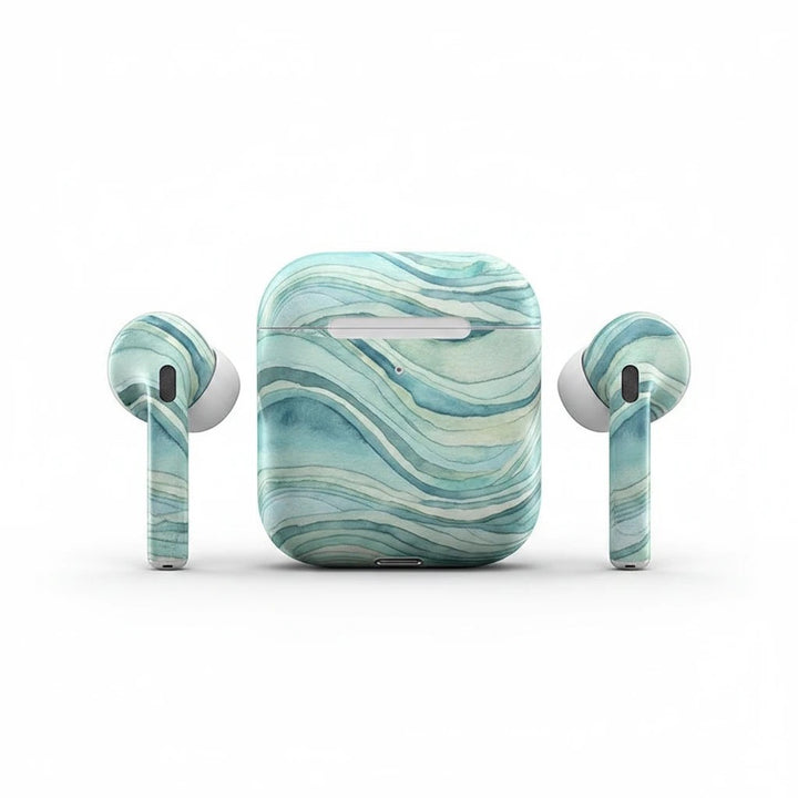 Sea Dragon Dreams ocean waves vinyl skin applied to an Apple AirPods charging case and earbuds with blue watercolor art.