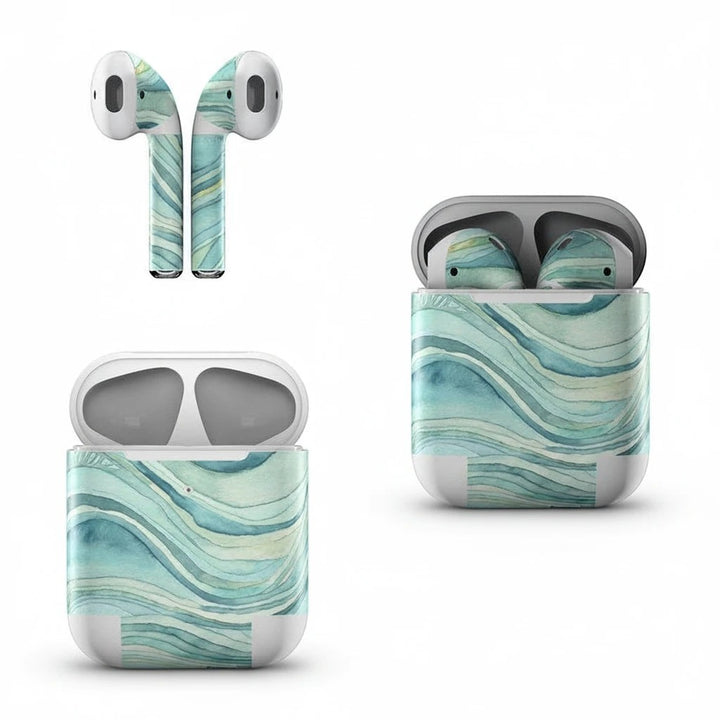 Sea Dragon Dreams ocean waves vinyl skin applied to Apple AirPods and charging case with blue and green watercolor art