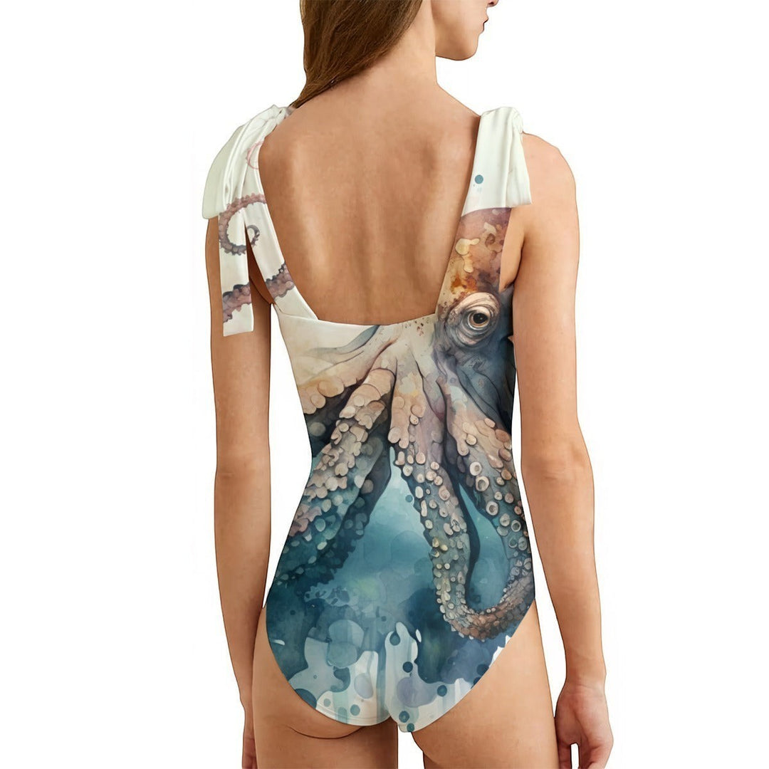 Sea Dragon Dreams women's one-piece swimsuit featuring a detailed octopus print, adjustable shoulder ties, and back view.