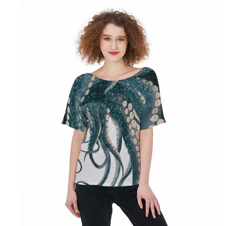 Woman wearing a Sea Dragon Dreams short-sleeve jersey t-shirt featuring a detailed teal octopus tentacle print.