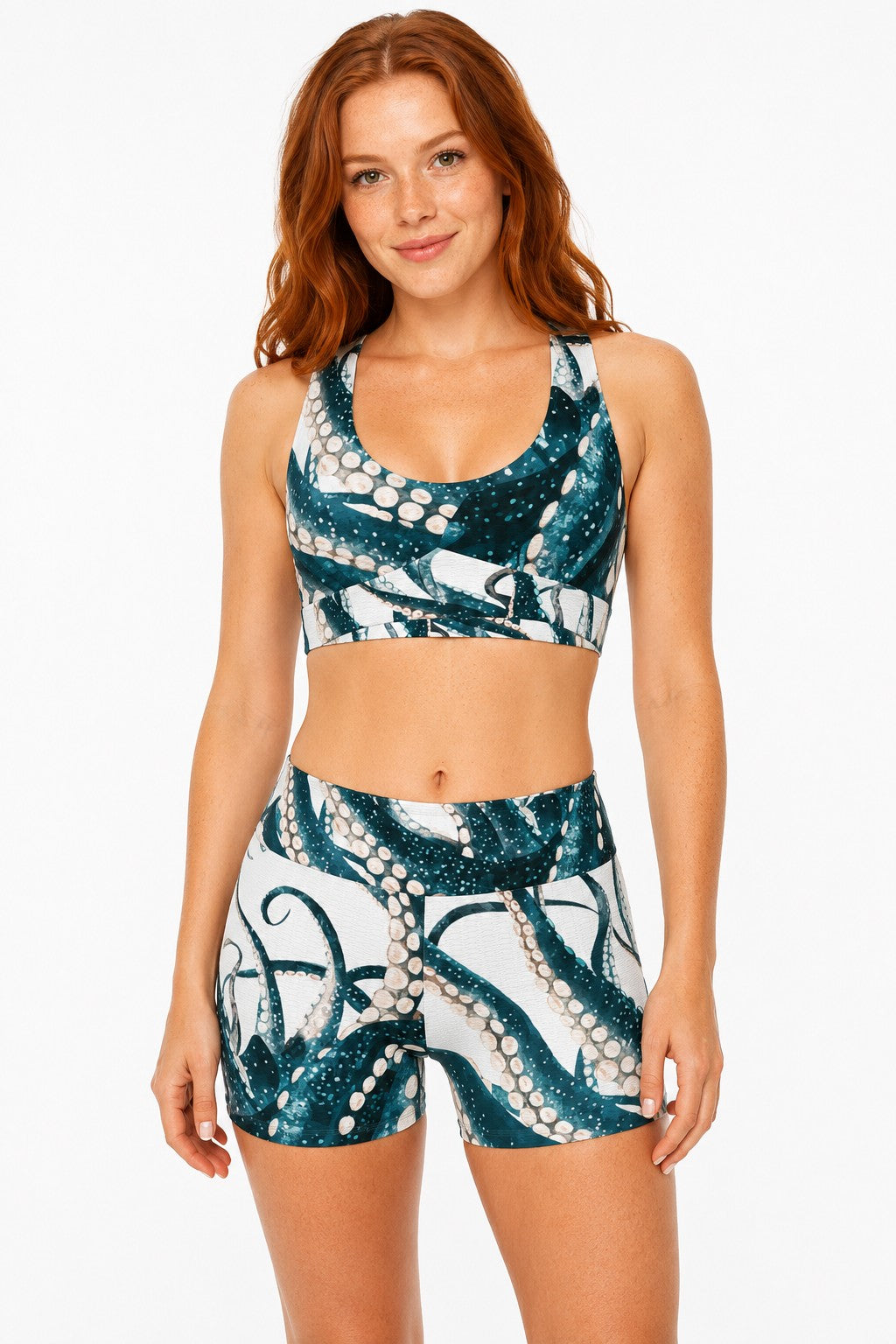 Sea Dragon Dreams athletic sports bra and shorts set with a teal and white octopus tentacle print on a model