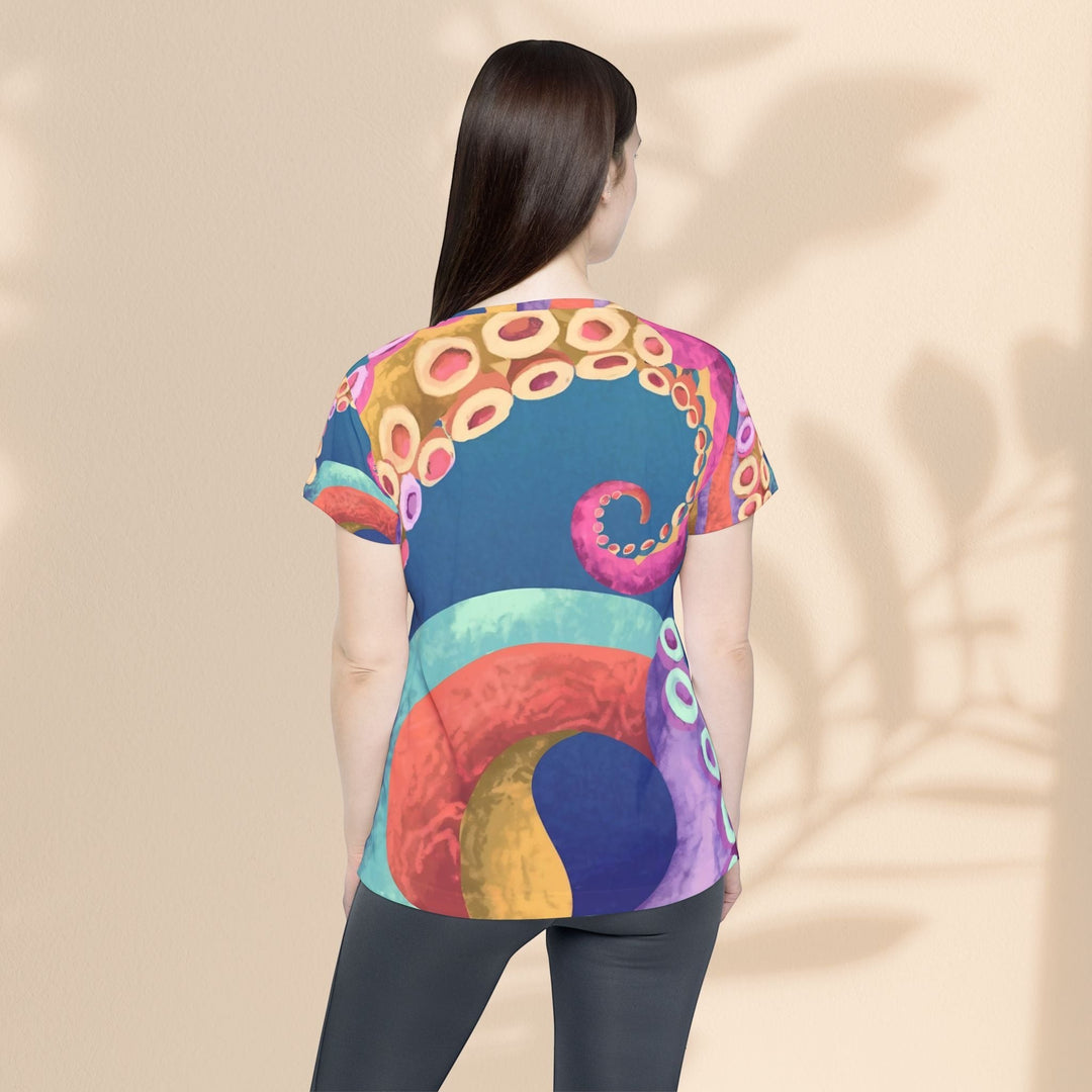 Back view of a woman wearing a Sea Dragon Dreams sports jersey with a vibrant, colorful octopus tentacle print.