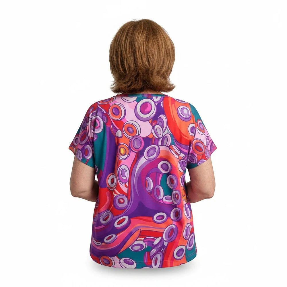 Back view of a woman wearing a Sea Dragon Dreams sports jersey with a vibrant, artistic purple and orange octopus print