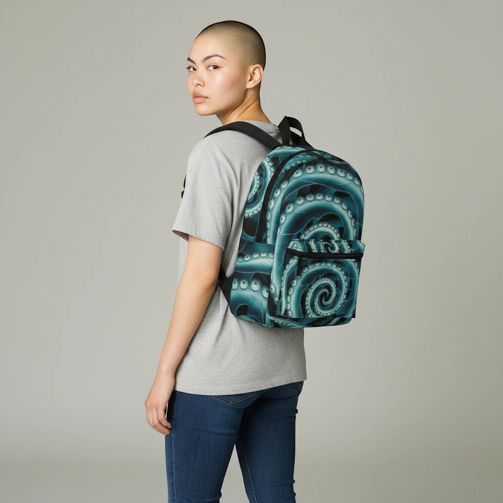 Sea Dragon Dreams Octopus Twist Backpack with teal tentacle print worn by a person in a grey t-shirt