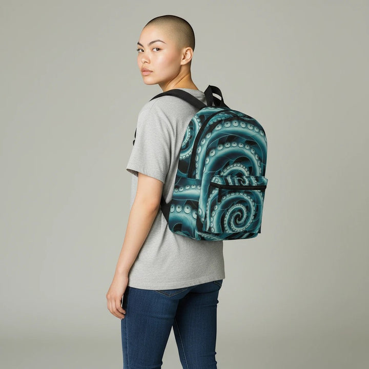 Sea Dragon Dreams Octopus Twist Backpack with teal tentacle print worn by a person in a grey t-shirt