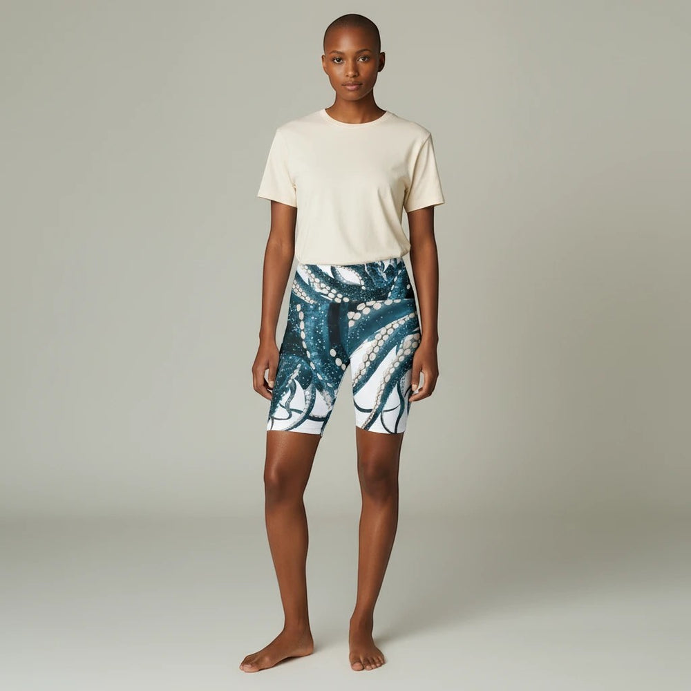Model wearing Sea Dragon Dreams workout shorts with a blue and white octopus tentacle print and a beige t-shirt.
