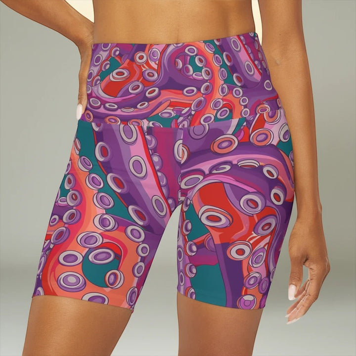 Sea Dragon Dreams high waisted yoga shorts featuring a vibrant purple and teal octopus tentacle pattern on a model.