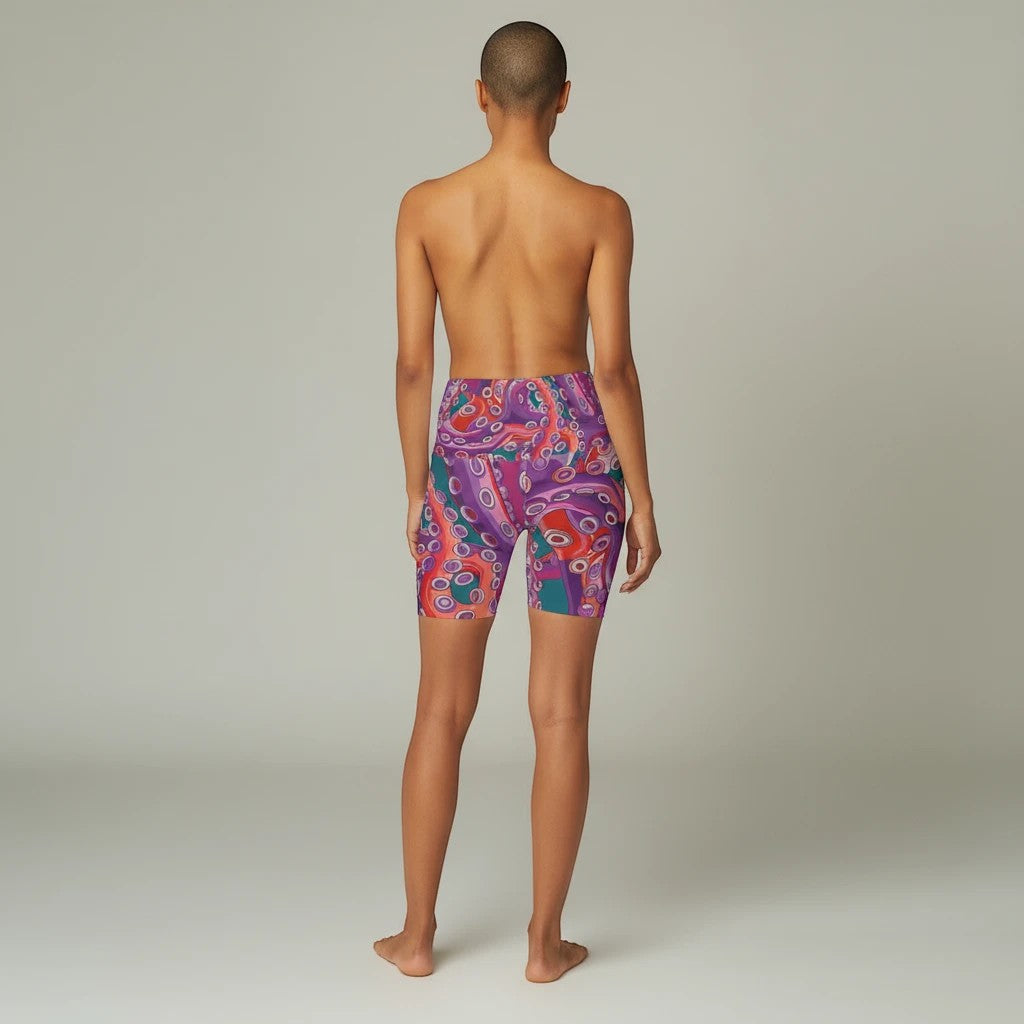 Sea Dragon Dreams high waisted yoga shorts with a vibrant purple and red octopus pattern on a model from behind