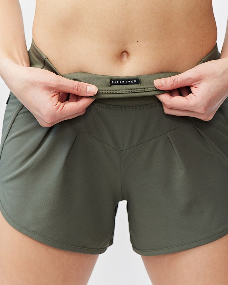 Sea Dragon Dreams Sheva olive green high rise running shorts with pleated detail and flat knit waistband