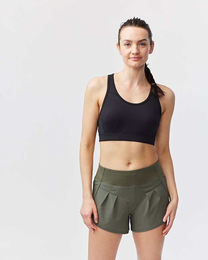 Sea Dragon Dreams Sheva high rise running shorts in olive green with pleated detail and knit waistband on a model