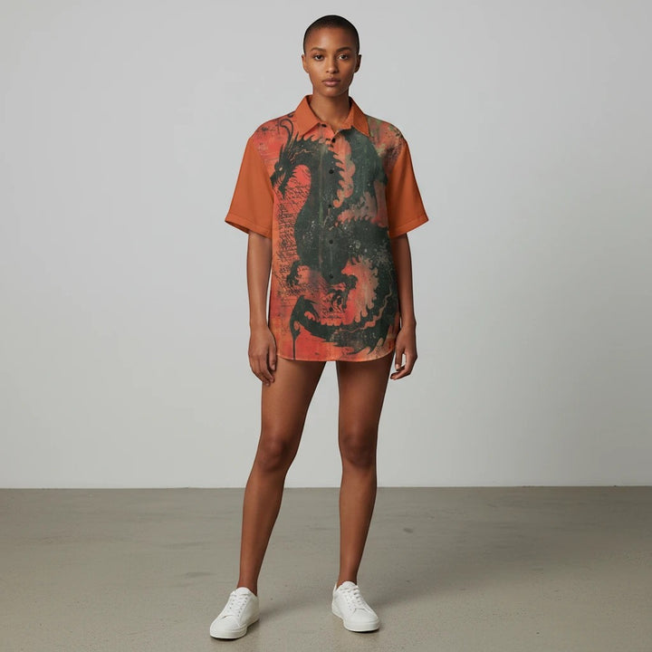 Model wearing a Sea Dragon Dreams orange collared shirt with a bold black dragon print, made of breathable cotton.