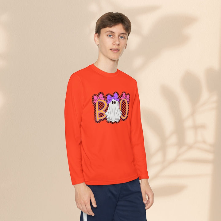 Sea Dragon Dreams youth long sleeve orange Halloween shirt with a ghost Boo graphic print worn by a young man.