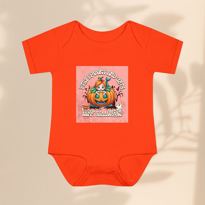 Sea Dragon Dreams infant bodysuit in bright orange with a Stay Spooky and Cute pumpkin Halloween graphic print.