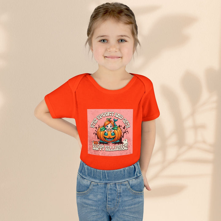 Sea Dragon Dreams infant bodysuit in orange with Stay Spooky and Cute pumpkin Halloween graphic on a young girl