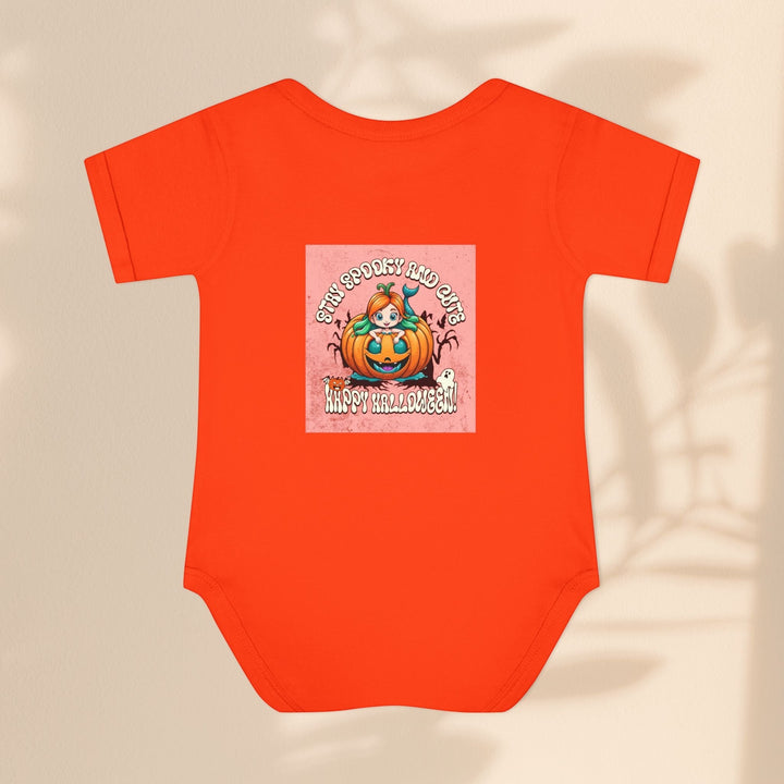 Sea Dragon Dreams infant bodysuit in bright orange with a Stay Spooky and Cute pumpkin Halloween graphic print.
