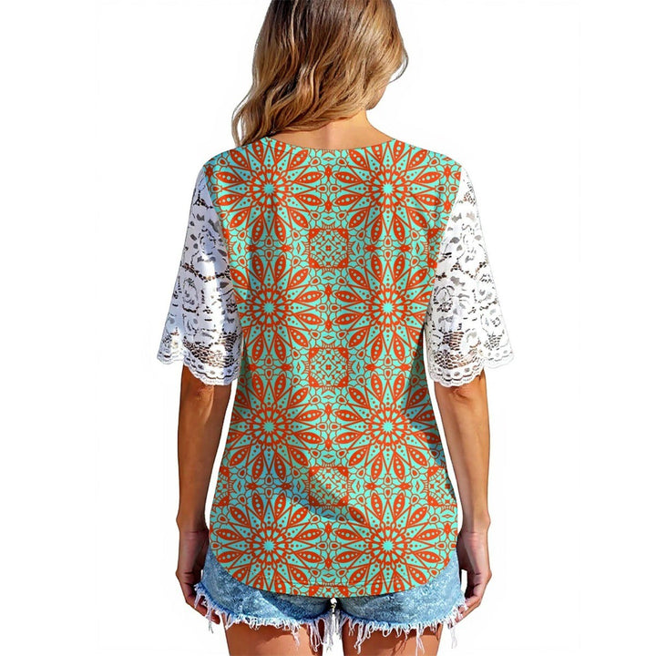Sea Dragon Dreams orange and teal patterned shirt with white lace sleeves worn by a woman from the back view