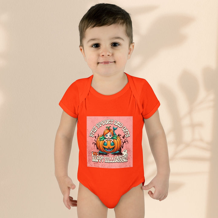 Sea Dragon Dreams infant bodysuit in bright orange with a Stay Spooky and Cute pumpkin Halloween graphic print