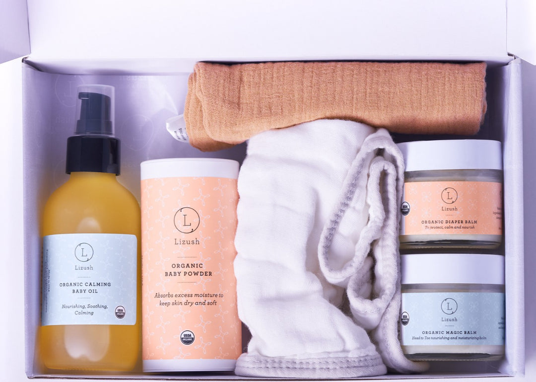 Sea Dragon Dreams organic baby gift set featuring natural skincare balms, baby oil, powder, and soft cotton cloths.