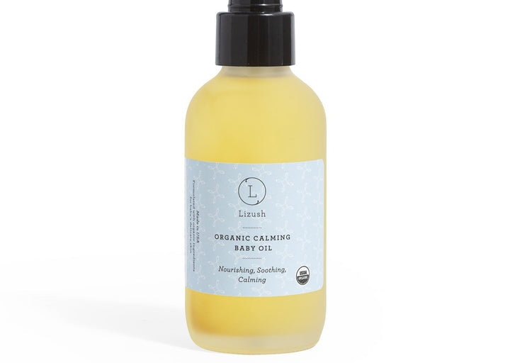 Sea Dragon Dreams organic calming baby oil in a clear glass bottle with a black pump dispenser and light blue label