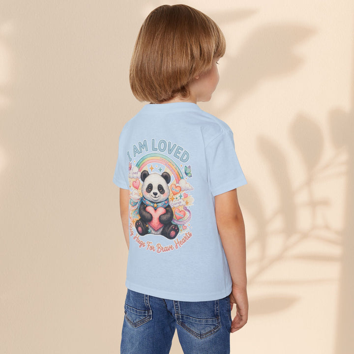 Sea Dragon Dreams toddler t-shirt in light blue featuring a Huggie Panda graphic with a rainbow and heart design.