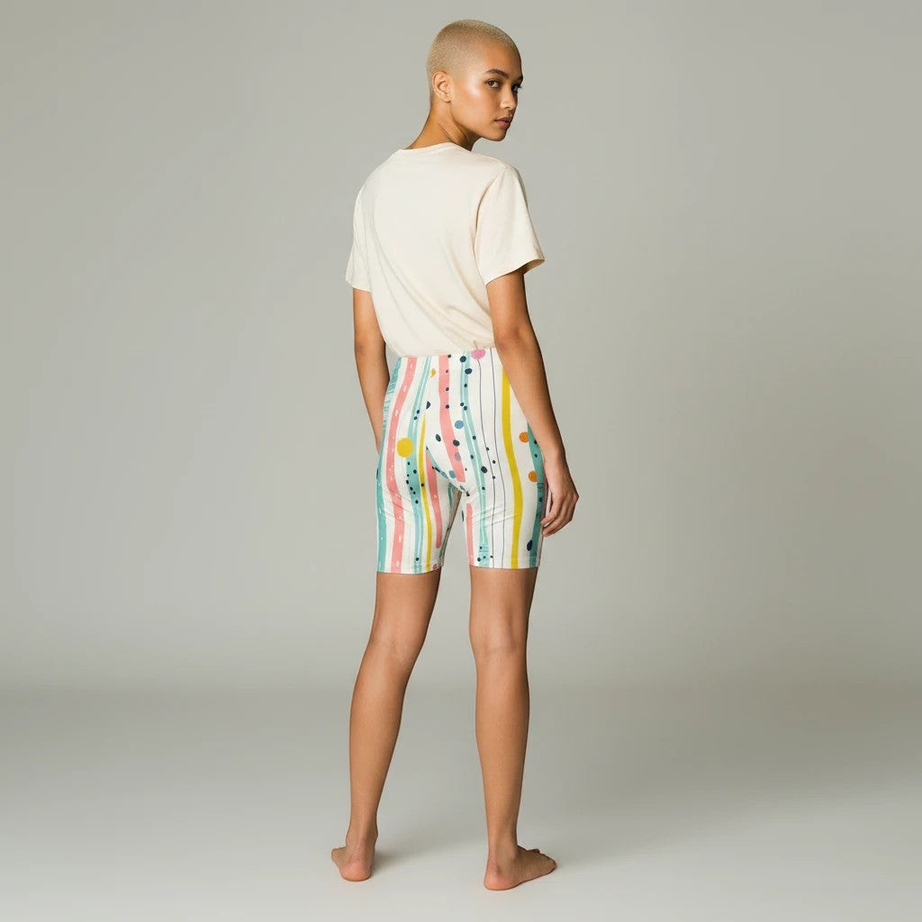 Model wearing Sea Dragon Dreams pastel biker shorts with a striped, polka dot, and brushstroke print, back view.