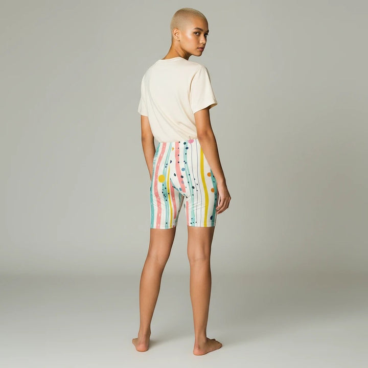 Model wearing Sea Dragon Dreams pastel biker shorts with a striped, polka dot, and brushstroke print, back view.